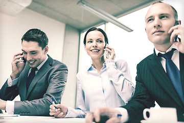 Image showing business team with smartphones having conversation