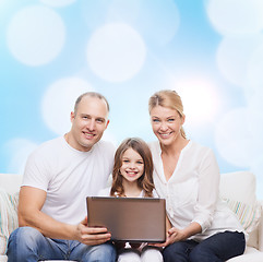 Image showing smiling family with laptop