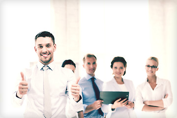 Image showing businessman in office showign thumbs up