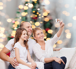 Image showing happy family with camera at home