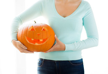 Image showing close up of woman with pumpkins at home