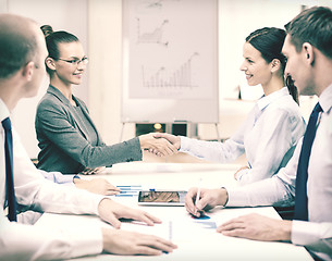 Image showing two businesswomen shaking hands in office