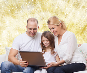 Image showing smiling family with laptop