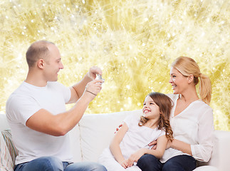 Image showing happy family with camera at home