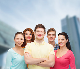 Image showing group of smiling teenagers over city background