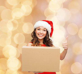 Image showing smiling woman in santa helper hat with parcel box