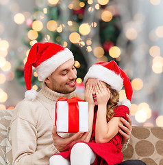 Image showing smiling daughter waiting for present from father