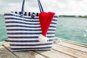 Image showing close up of beach bag and santa helper hat