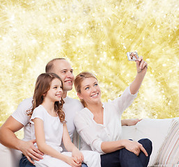 Image showing happy family with camera at home