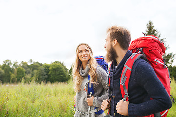 Image showing smiling couple with backpacks hiking