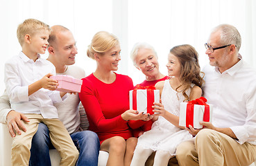 Image showing smiling family with gifts at home