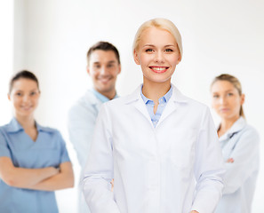 Image showing smiling female doctor with group of medics