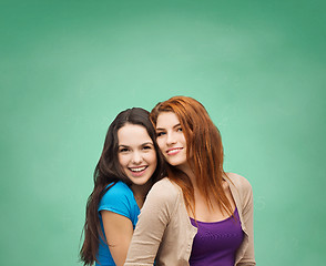 Image showing smiling teenage girls hugging