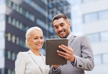 Image showing smiling businessmen with tablet pc outdoors