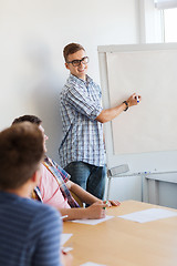 Image showing group of smiling students with white board