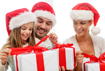 Image showing happy family sitting on couch at home