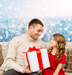 Image showing smiling father and daughter with gift box