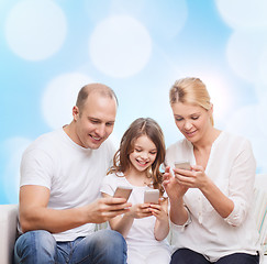 Image showing happy family with smartphones