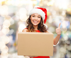 Image showing smiling woman in santa helper hat with parcel box