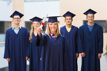 Image showing group of smiling students in mortarboards