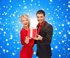 Image showing smiling man and woman with present