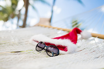 Image showing hammock with santa helper hat and shades