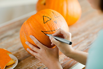 Image showing close up of woman with pumpkins at home