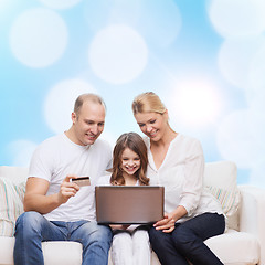 Image showing happy family with laptop computer and credit card