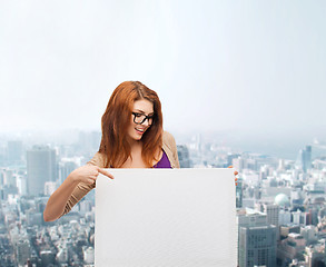 Image showing smiling teenage girl in glasses with white board