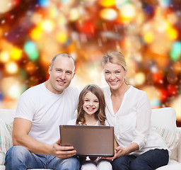 Image showing smiling family with laptop