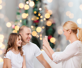 Image showing happy family with camera at home