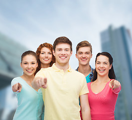 Image showing group of smiling teenagers over city background