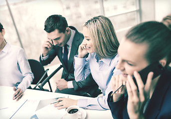 Image showing business team with smartphones having conversation