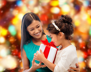 Image showing happy mother and little girl with gift box