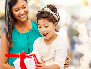 Image showing happy mother and little girl with gift box