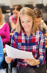 Image showing group of smiling students with notebook
