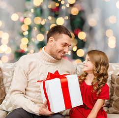 Image showing smiling father and daughter with gift box