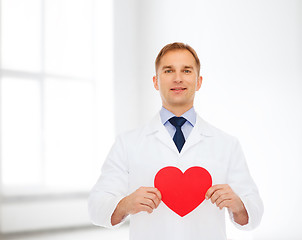 Image showing smiling male doctor with red heart