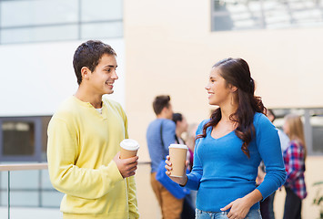 Image showing group of smiling students with paper coffee cups