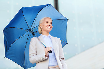 Image showing young smiling businesswoman with umbrella outdoors