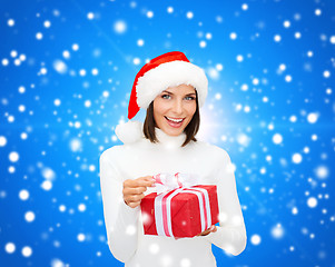 Image showing smiling woman in santa helper hat with gift box