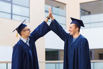 Image showing smiling students in mortarboards