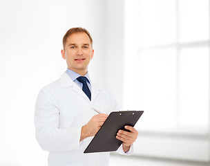 Image showing smiling male doctor with clipboard