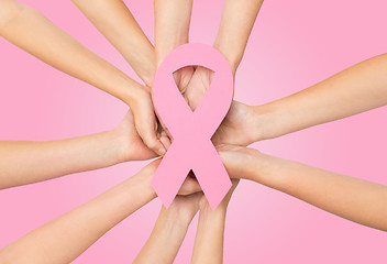 Image showing close up of hands with cancer awareness symbol