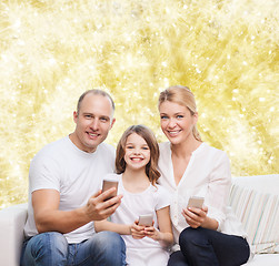 Image showing happy family with smartphones