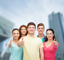 Image showing group of smiling teenagers over city background