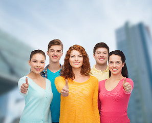 Image showing group of smiling teenagers over city background