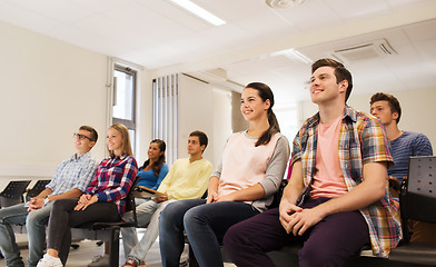 Image showing group of smiling students in lecture hall