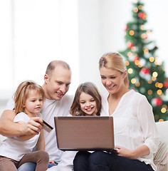 Image showing happy family with laptop computer