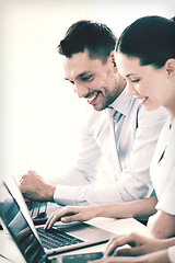 Image showing man and woman working with laptop in office